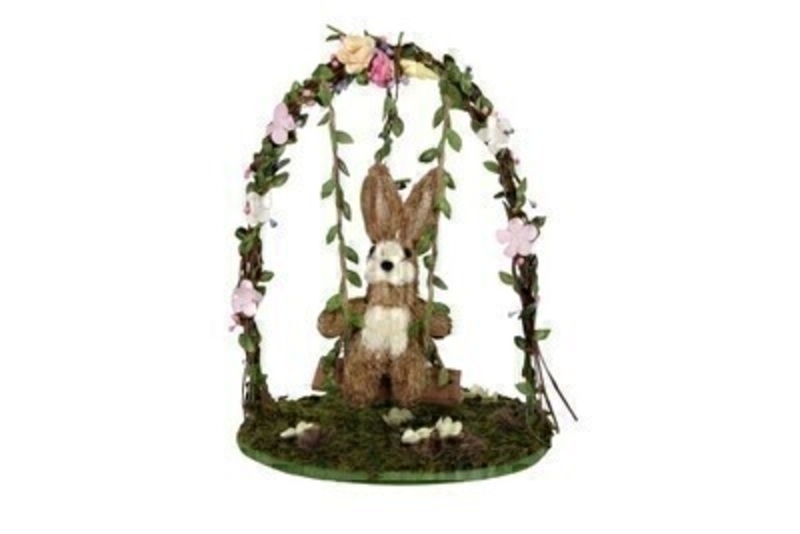 Cute bristle Easter bunny sitting on a swing arch decorated with flowers.  Ornament from designer Giesela Graham who designs unique Easter gifts and decorations. Would make a lovely Easter gift.